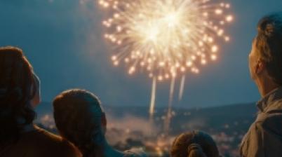 Family enjoying a fireworks display while observing fireworks safety practices.