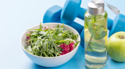 bowl of vegetables, water bottle and hand weights