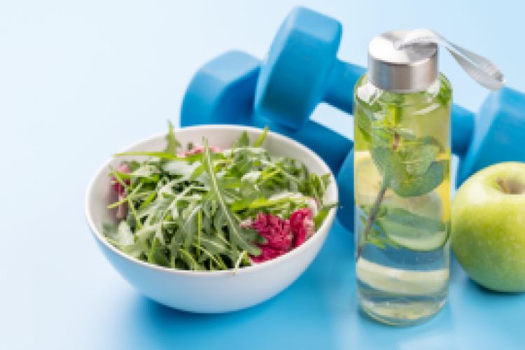 bowl of vegetables, water bottle and hand weights